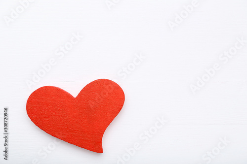 Red valentine heart on white wooden table