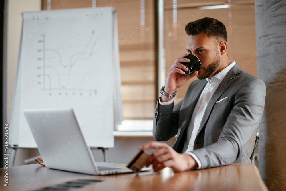 Portrait of handsome businessman working in office and drinking coffee. Portrait of handsome businessman working in office and drinking coffee.