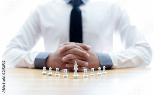 Business men make plans to play chess with Prudence and success, Management or leadership concept.