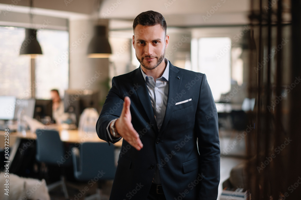 Fototapeta premium Businessman gives a hand for handshaking