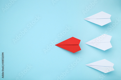 Paper plane leader on blue background