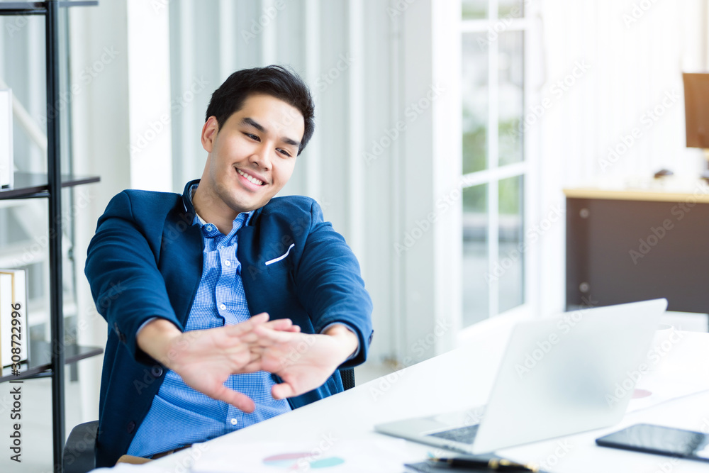 Happy of successful asian young businessman on laptop computer, tablet with blank touch screen isolated and Pen on notebook on White wooden table background in office Happy of successful asian young businessman on laptop computer, tablet with blank touch screen isolated and Pen on notebook on White wooden table background in office