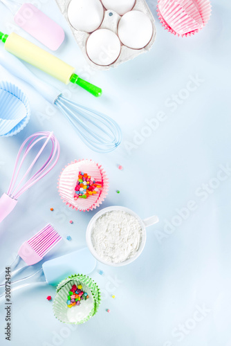 Ingredients and utensils for baking - eggs, flour, sugar, butter, milk on a light blue background.Top view copy space for text.