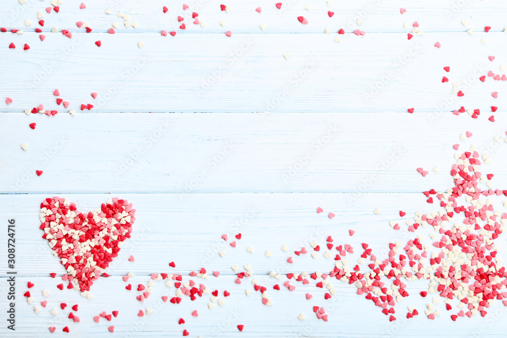 Obraz premium Heart shaped sprinkles on wooden table