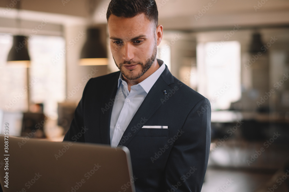 Portrait of handsome businessman. Man with his lap top in office. Portrait of handsome businessman. Man with his lap top in office.
