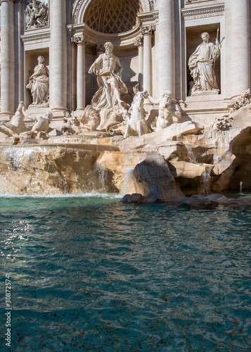 Lots of coins in the Trevi Fountain in Rome as seen from the front