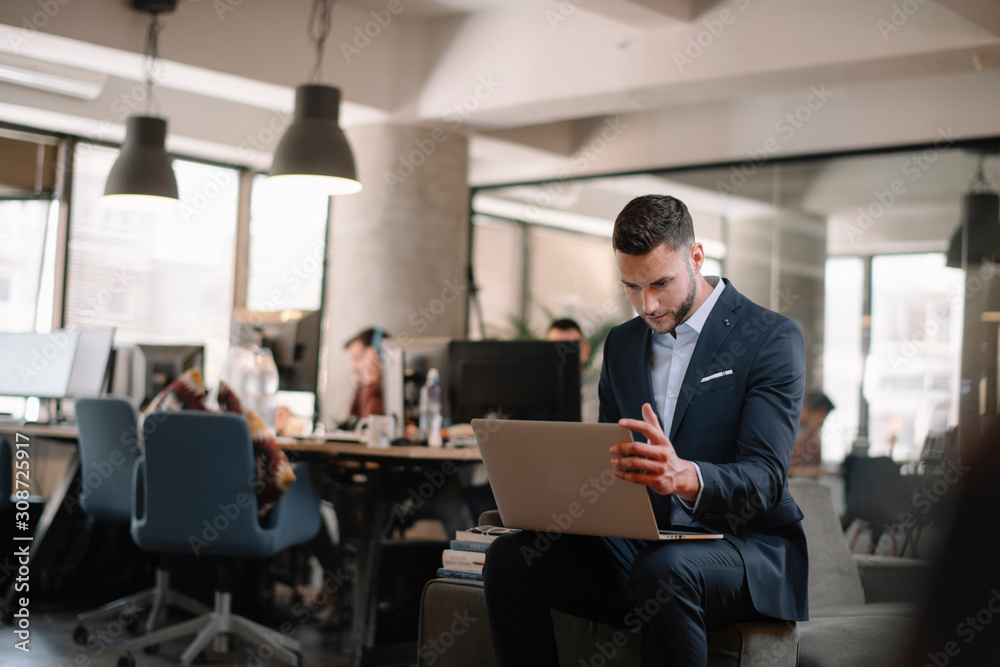 Portrait of handsome businessman. Man with his lap top in office. Portrait of handsome businessman. Man with his lap top in office.