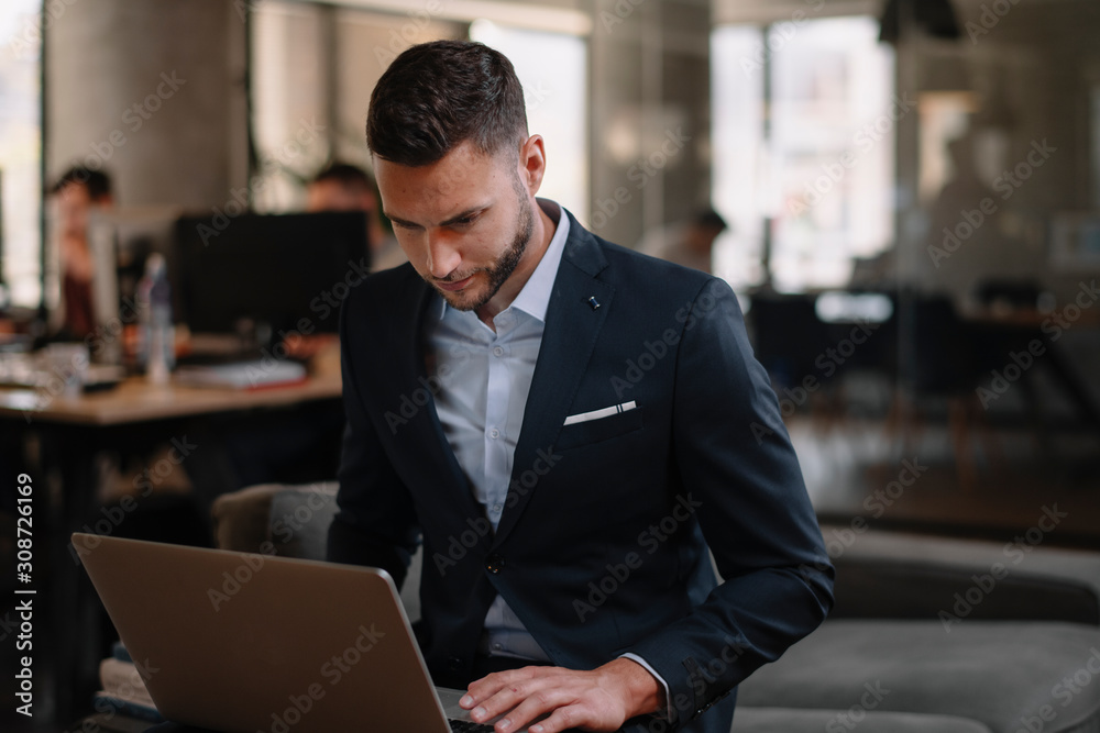 Portrait of handsome businessman. Man with his lap top in office. Portrait of handsome businessman. Man with his lap top in office.