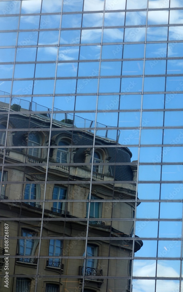 modern office building with reflection in windows of building