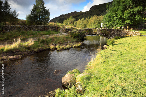 Summer  Packhorse stone bridge over Watendlath Beck  Watendlath Tarn  Lake District National Park  Cumbria  England  UK