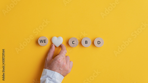 Male hand making a We love CBD sign photo
