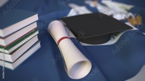 Graduation cap, books and diploma on the flag of Louisiana. Higher education in the USA related conceptual 3D animation photo