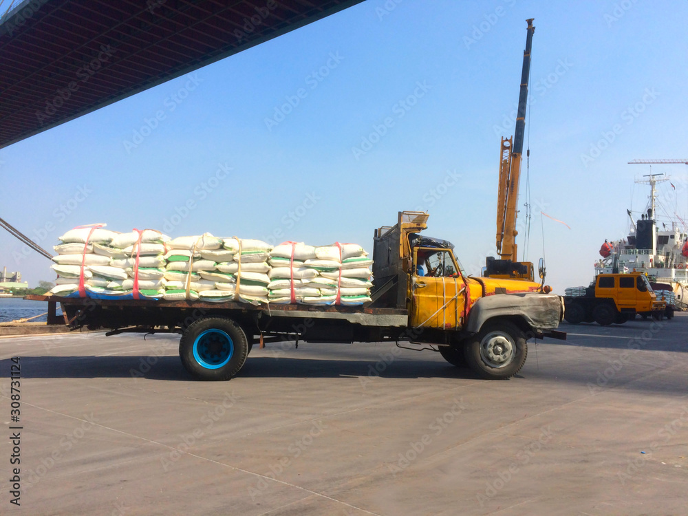 Ten wheel truck loading sack goods to customers.