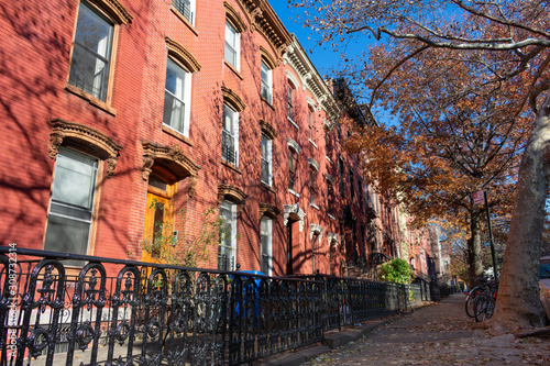 Row of Colorful Old Homes in Greenpoint Brooklyn New York along the Sidewalk during Autumn