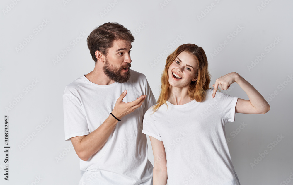 young couple in t-shirts chatting young couple in t-shirts chatting