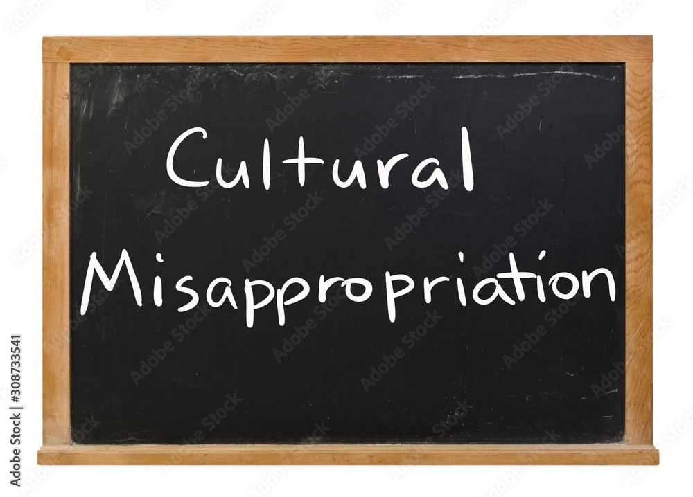 Obraz premium Cultural Misappropriation written in white chalk on a black chalkboard isolated on white
