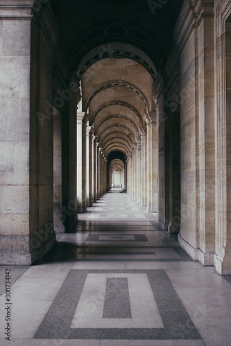 Vertical shot of an outdoor hallway of a historic building with outstanding architecture photo