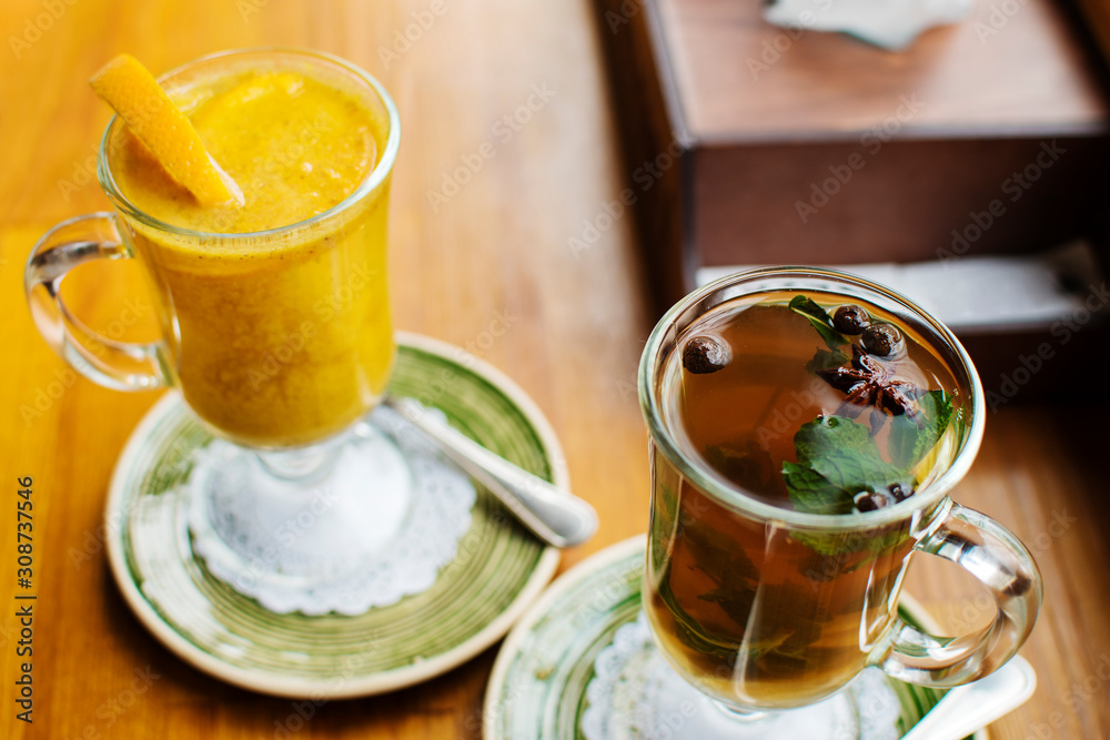 two warming traditional drinks grog and mulled wine with orange and cinnamon on a dark background close up