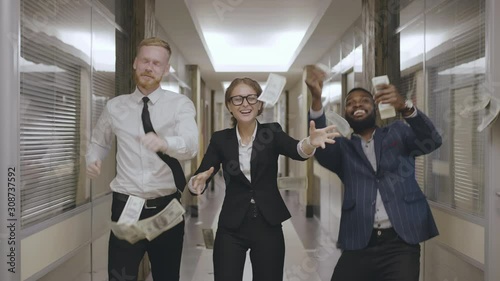 Happy entrepreneurs dancing under money rain photo