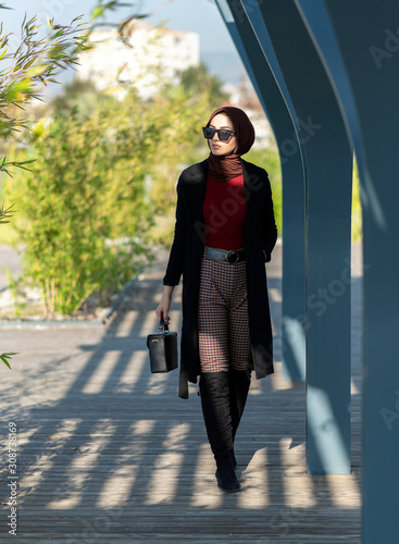 modern young muslim woman walking in the city