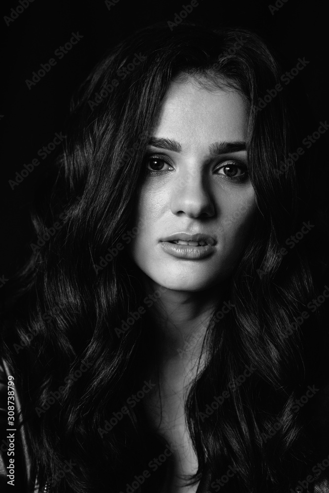 portrait of a young brunette girl with makeup and styling long hair