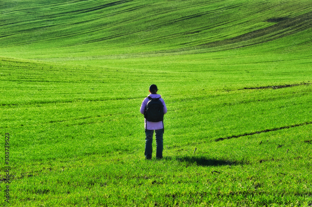 man in the field. picturesque clouds over a hilly field man in the field. picturesque clouds over a hilly field