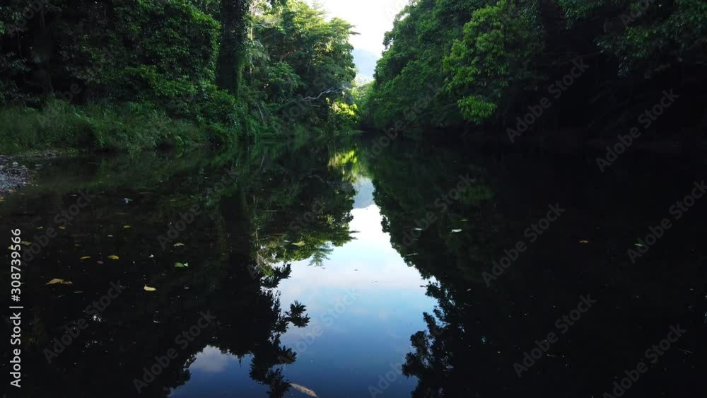 sped up movement of dark reflective creek with sky reflection on the water, sped up movement of dark reflective creek with sky reflection on the water,