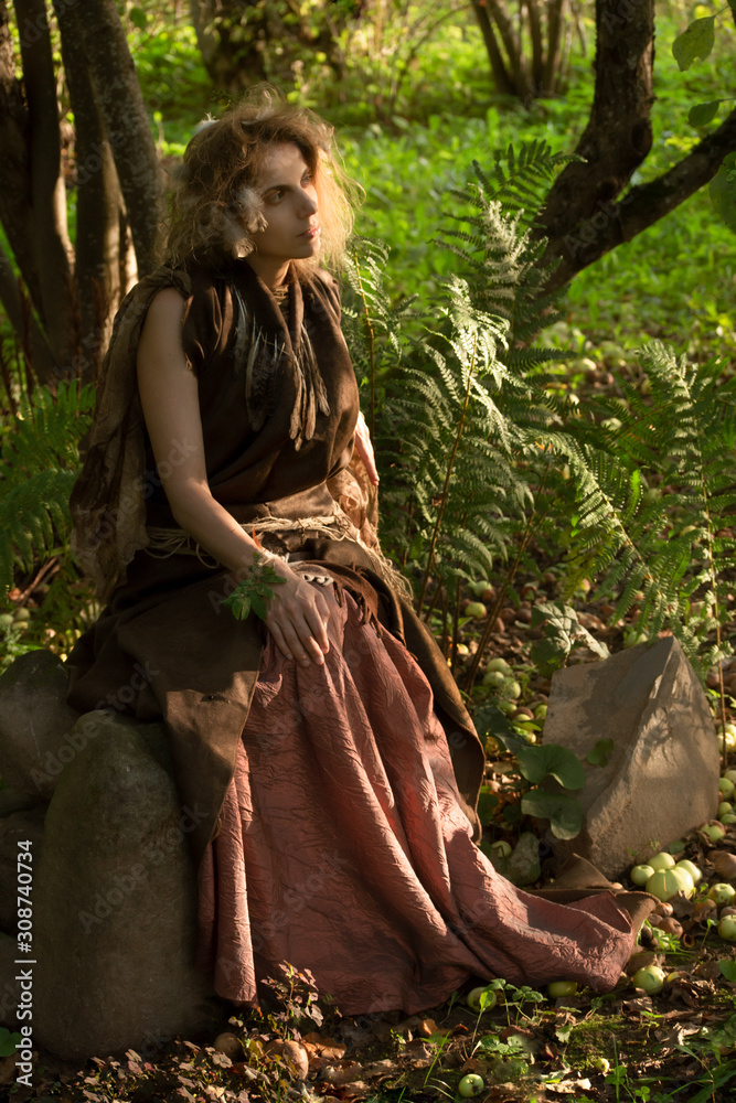Witch with rejuvenating apple in garden Witch with rejuvenating apple in garden