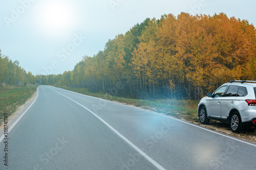 Suv car in autumn on the road.