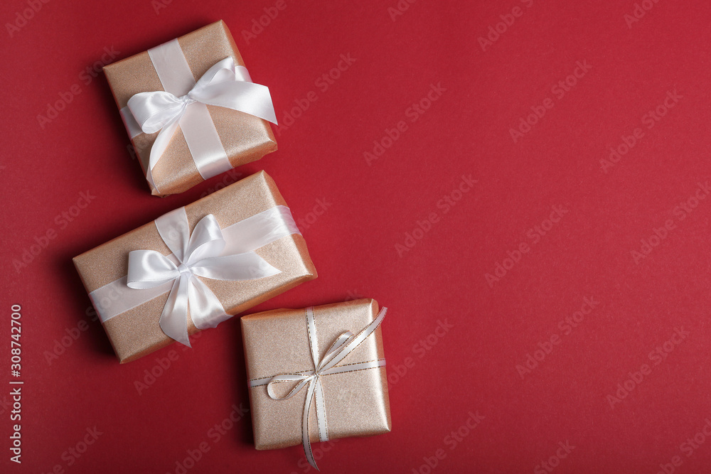 Gifts in gold packaging on a colored background with place for text top view. birthday, christmas, new year, mother's day, march 8, valentines day Gifts in gold packaging on a colored background with place for text top view. birthday, christmas, new year, mother's day, march 8, valentines day
