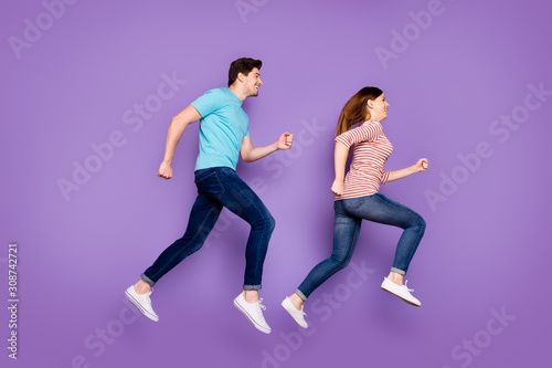 Full length profile photo of crazy funky guy lady rushing fast summer weekend season discounts wear casual stylish blue striped t-shirts jeans shoes isolated purple color background