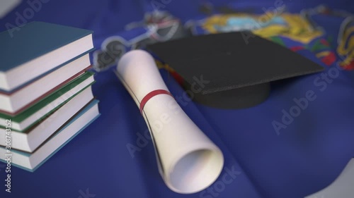 Graduation cap, books and diploma on the flag of Pennsylvania. Higher education in the USA related conceptual 3D animation photo