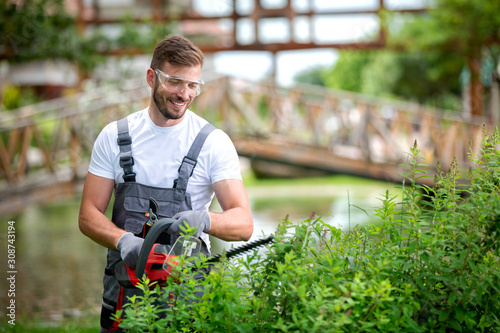 Handsome man dressed in gardening outfit Fototapet