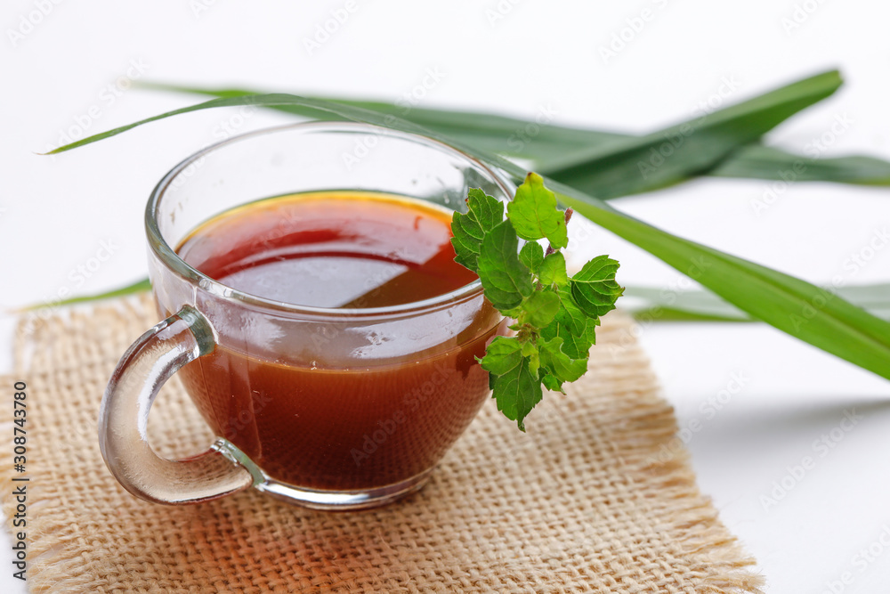 Black tea with lemon and ginger over white background Black tea with lemon and ginger over white background