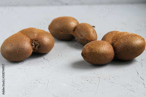 The ugly kiwi fruit. Tasty and healthy. Vegetarian food. On a light background.