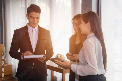 Group of business people having meeting together in modern office. Businesswoman explaining new business ideas to colleagues.