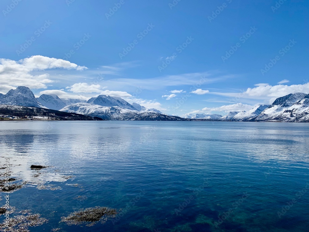 Crystal water at the edge of the coastal mountains, Svensby, Troms, Norway Crystal water at the edge of the coastal mountains, Svensby, Troms, Norway