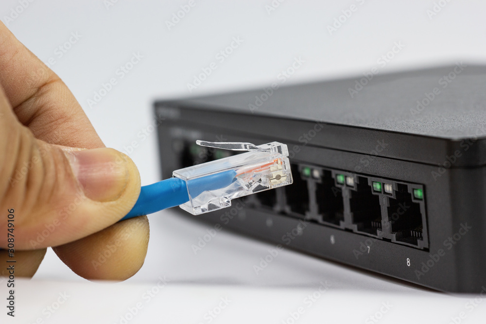 Hand of man holding The network cables to connect Lan port Hand of man holding The network cables to connect Lan port