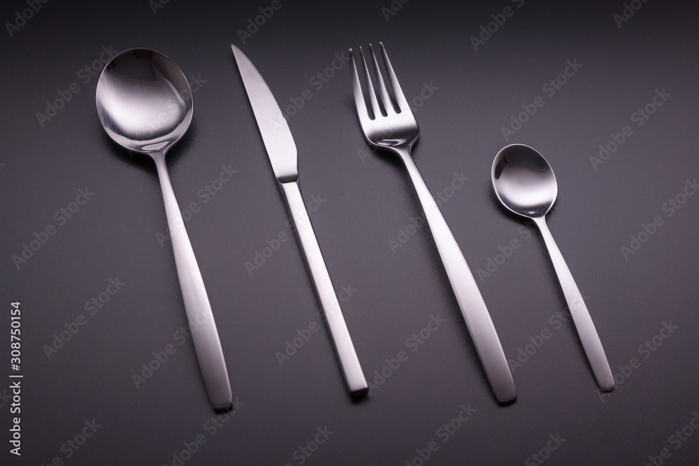 Shiny cutlery over a black background Shiny cutlery over a black background