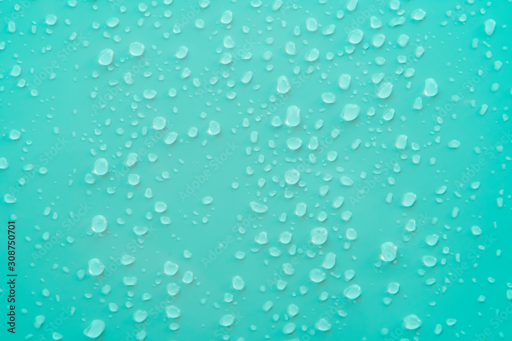 pure water drop above surface of ocean cyan color background