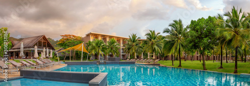 Panorama of the chic five star hotel with pool the sands of katathani. Evening order, palm trees and green grass. vacation spot