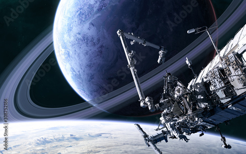 Fototapeta Naklejka Na Ścianę i Meble -  Space station on background of blue planet with a system of rings in deep space. Science fiction. Elements of this image furnished by NASA