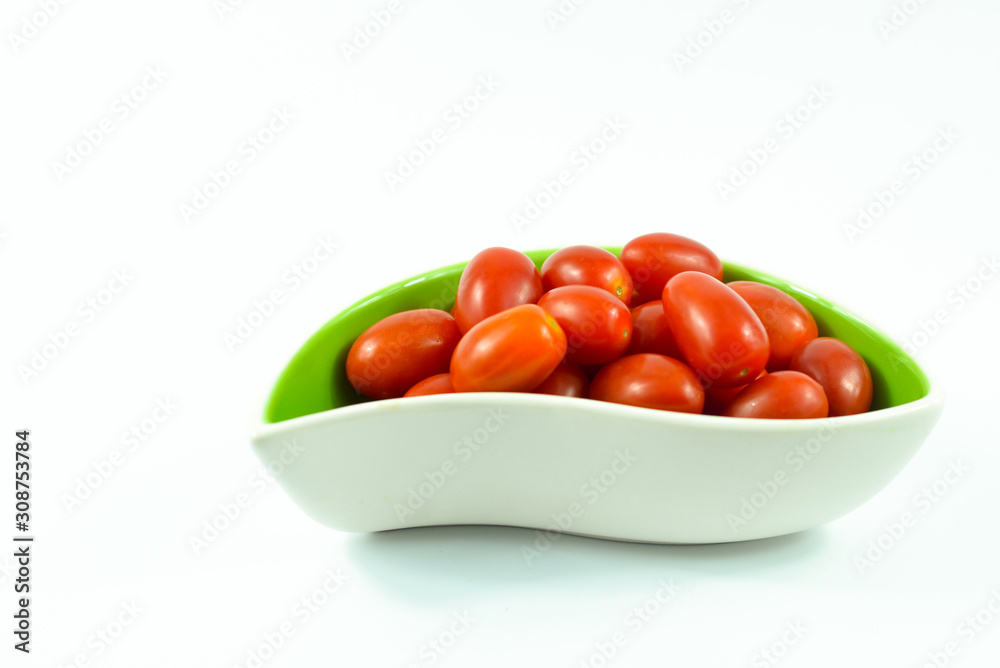 Red grape tomatoes in a bowl isolated on white background. Red grape tomatoes in a bowl isolated on white background.