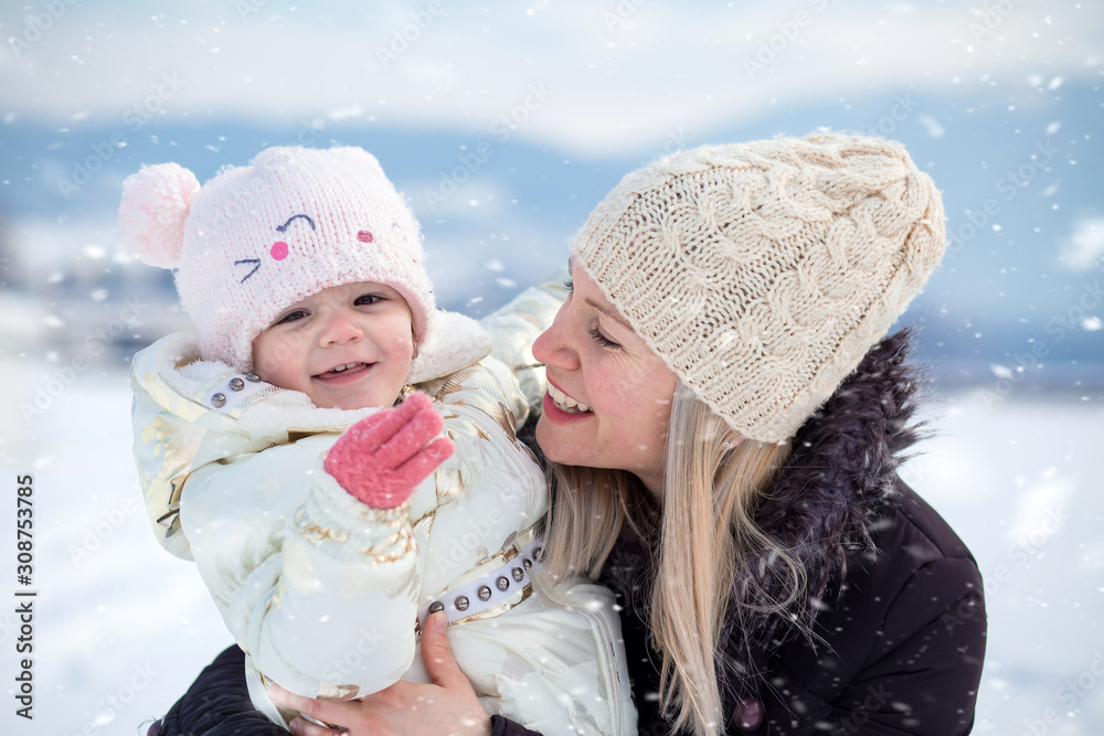 Happy family, mom with daughter, winter time, outdoor activity Happy family, mom with daughter, winter time, outdoor activity