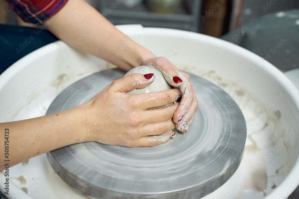 Woman making ceramic pottery on wheel, hands closeup. Concept for woman in freelance, business, creative hobby. Earn extra money, side hustle Woman making ceramic pottery on wheel, hands closeup. Concept for woman in freelance, business, creative hobby. Earn extra money, side hustle
