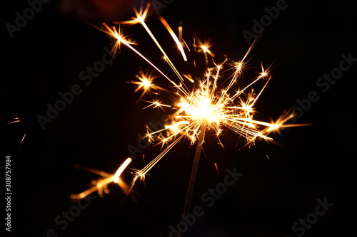 burning sparkler firework. Happy new year and Merry christmas concept. Happy holidays. Abstract blurred of Sparklers for celebration. Magic light. Winter Xmas decoration. Realistic light effect. Party