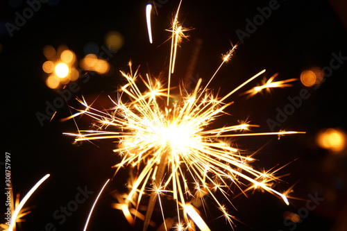 burning sparkler firework. Happy new year and Merry christmas concept. Happy holidays. Abstract blurred of Sparklers for celebration. Magic light. Winter Xmas decoration. Realistic light effect. Party