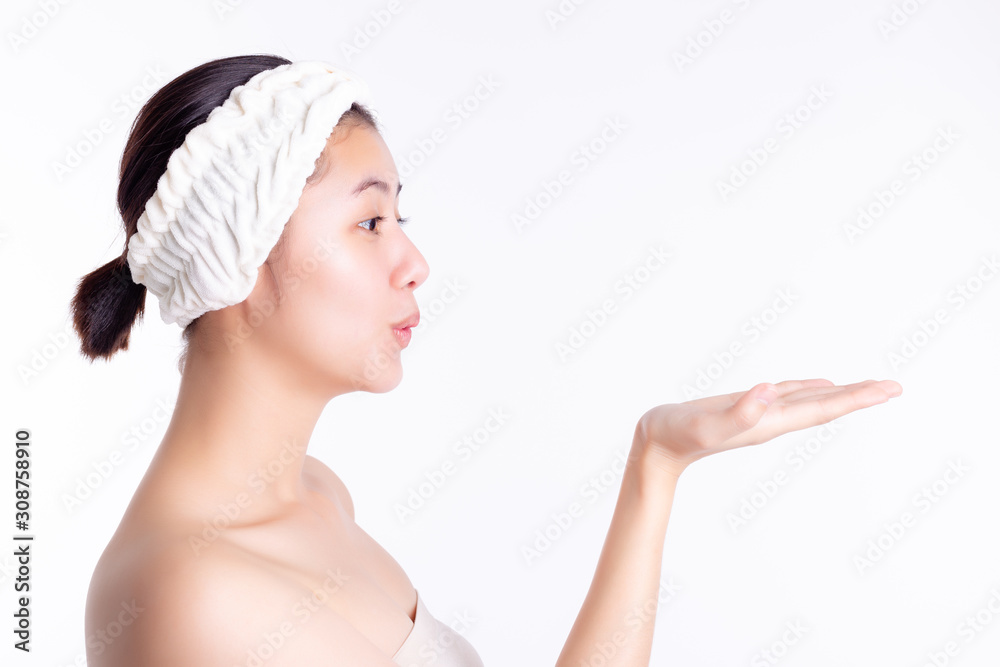Beautiful young asian woman showing, looking at hand of copy space. Attractive beautiful girl love product, goods. Pretty woman gets satisfied product of skin care, soap, after bath. skincare concept Beautiful young asian woman showing, looking at hand of copy space. Attractive beautiful girl love product, goods. Pretty woman gets satisfied product of skin care, soap, after bath. skincare concept