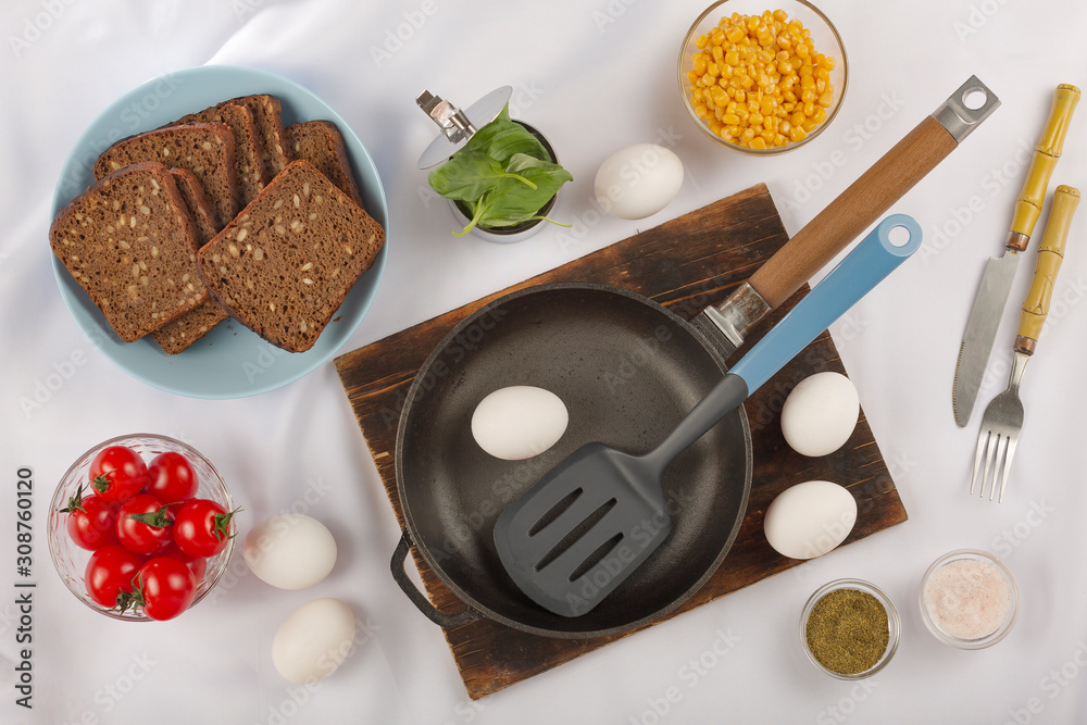 Cooking breakfast. Eggs, cherry tomatoes and dark bread cereal. Eco food. Cooking breakfast. Eggs, cherry tomatoes and dark bread cereal. Eco food.
