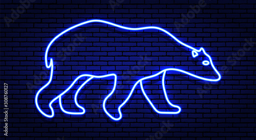 Neon winter sign. The contour of the white polar bear in shades of blue. Against a brick wall, with a shadow.